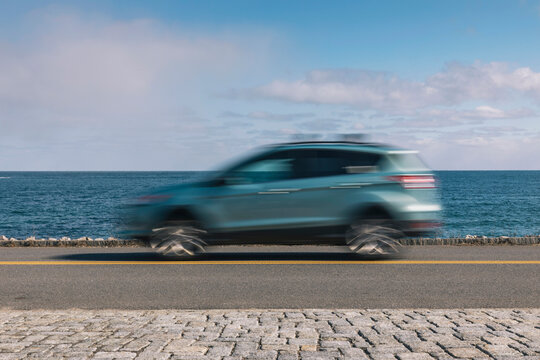 Car Speeding On Seascape On Coast Of New England