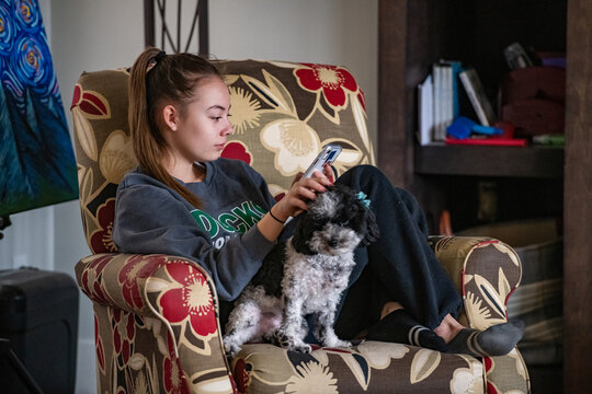 Teen Girl with Dog Happy to be Connected on Cell Phone