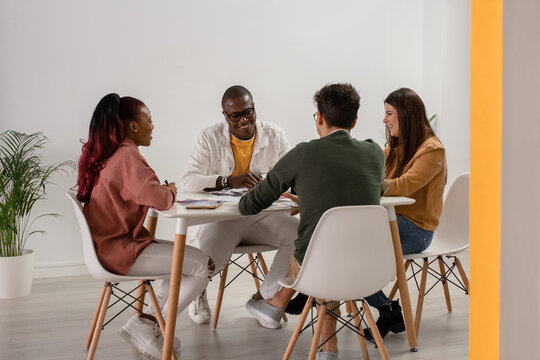 Cheerful multiethnic colleagues working on project together