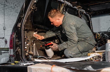 Technician cleaning insides of car