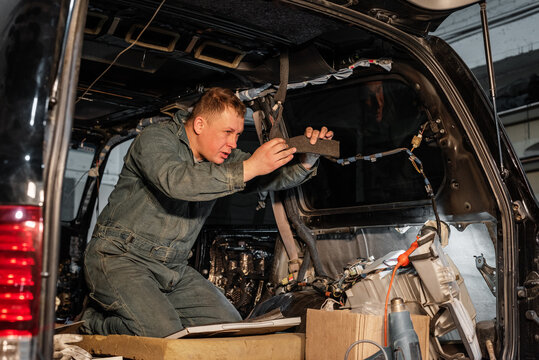 Mechanic repairing car electric cords