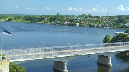 The waving flag of Estonia on the bridge in Narva Estonia