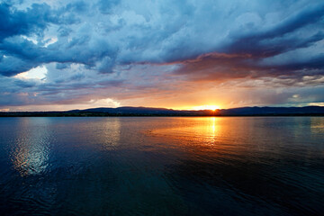 Fototapeta na wymiar Dramatic clouds over the lake. Sunset. Storm.
