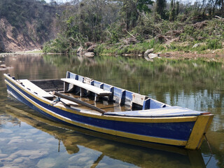 Obraz premium Old wooden fishing boat on the river.Peaceful Landscape.