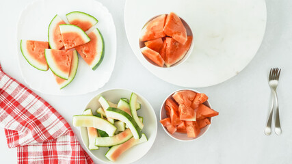 Fruit salad. Fresh watermelon slices close up in a bowls on kitchen table directly from above
