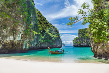 Thai traditional wooden longtail boat and beautiful beach in Thailand.