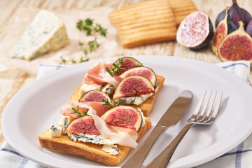 two sandwiches for breakfast with blue cheese ham and fresh figs.