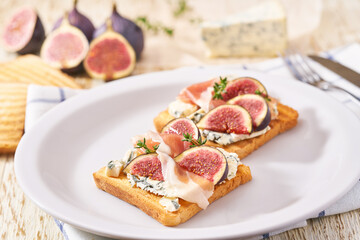 two sandwiches for breakfast with blue cheese ham and fresh figs.