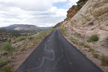 Mountain road going through public park with steep rock face
