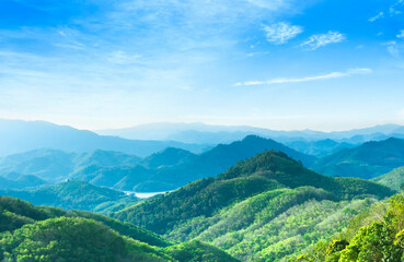 World Environment Day concept: Panoramic view of mountain range covered by forest with blue sky