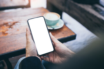 cell phone mockup blank white screen.woman hand holding texting using mobile on desk at coffee shop.background empty space for advertise.work people contact marketing business,technology