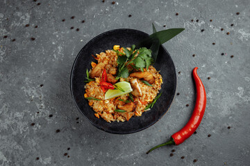 Thai rice with chicken. Thai dish of rice, chicken, Yalta onion, corn, pineapple, tomato, soy sauce, chili paste, cilantro, lime, chili pepper