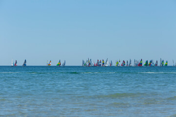 Colorful sailboat regatta on the ocean horizon line