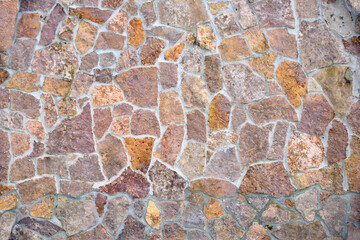 Stone wall with different pieces of tiles. Background