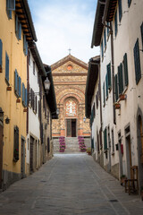 View of the narrow street facing the Church of Santa Maria in Panzano in Chianti, Tuscany, Italy