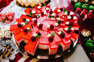 Sweet table. A plates with cakes. Table with sweets, buffet. Dessert table for a party goodies. Party reception, decorated delicious in restaurant. Candy bar.