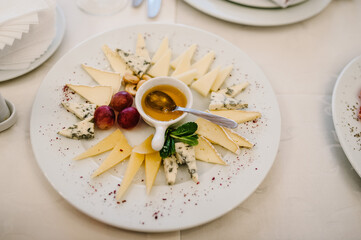 Cheese. Food. Festive table with dishes. Dish. Side view.