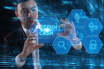 Business, Technology, Internet and network concept. Young businessman working on a virtual screen of the future and sees the inscription: Bitcoin cash