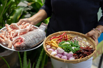 person holding a basket of vegetables