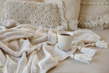 Obraz na płótnie Canvas Cup of coffee with warm plaid. Copy space. Flat lay, top view
