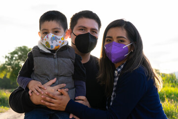 family with masks in the park