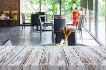 Old style white wooden table in coffee shop blurred background.