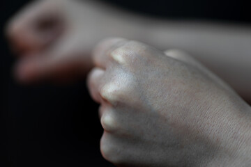 two fists on black background