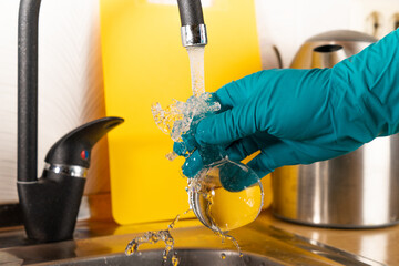 water purification specialist tap water pours into a glass flask.