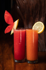 Watermelon and papaya smoothie on wood background. Healthy juice. Detox, diet food, vegetarian food, healthy eating concept. Red orange Vitamin drink diet vegan food concept refreshing fruit beverage