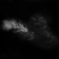 White vapour spray steam from air saturator. Smoke fragments on a black background. Abstract background