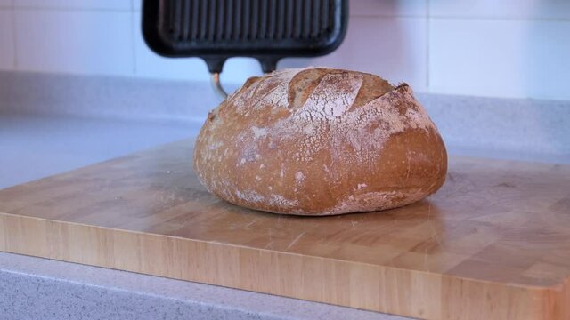 Diagonal pan from left to right across the surface of freshly baked homemade sourdough bread