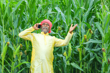Indian farmer talking on mobile phone at Agriculture field