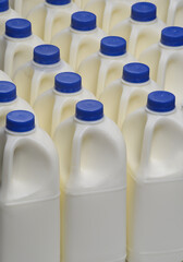 Plastic 1 litre containers of milk manufactured from polymer for consumer use.  