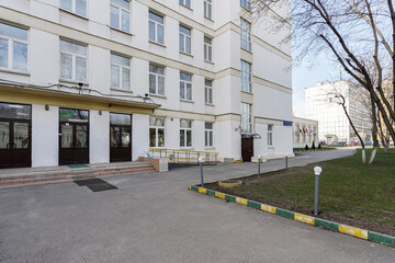 Fototapeta na wymiar School building with an empty courtyard.