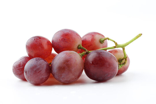 Ripe red grapes on a white background.