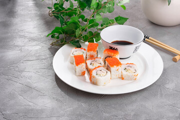 Untraditional Japanese sushi roll masaga caviar with with ham, cucumber and Japanese omelet,