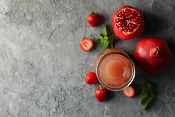 Bottle - jug with pomegranate juice on gray background