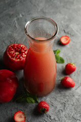 Bottle - jug with pomegranate juice on gray background