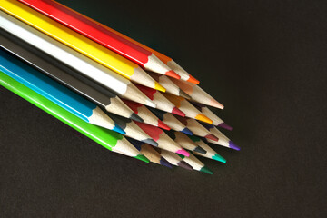 Colored pencils on a black background