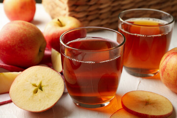 Glasses of fresh apple juice on white background