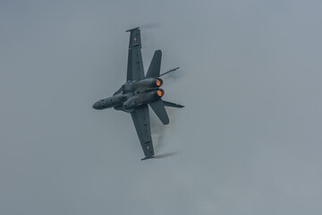 jet accelerates in the rain in a air show