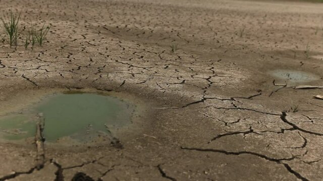 Dry lake or river, cracked land, natural disaster, drought, panning shot