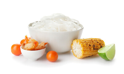 Tasty rice noodles with ingredients on white background