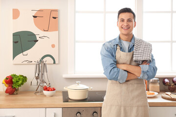 Portrait of handsome young man in kitchen