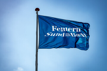 Flag with logo of the Femern Belt connection project that will link Denmark and Germany via an underwater tunnel.