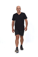 Fototapeta premium front view of a man wearing with sportswear t-shirt and shorts walking on white background,