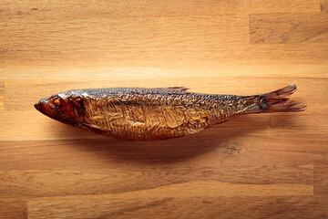 Smocked herring on a wooden table.