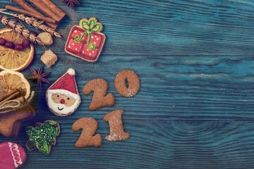 New year 2021, xmas and christmas theme: holiday gingerbreads on wooden background