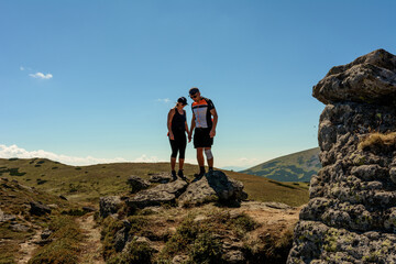Silhouette of a couple on top of a mountain, tourists on top of a Carpathian mountain, Montenegrin ridge.
