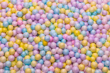 Purple, yellow, blue plastic balls.